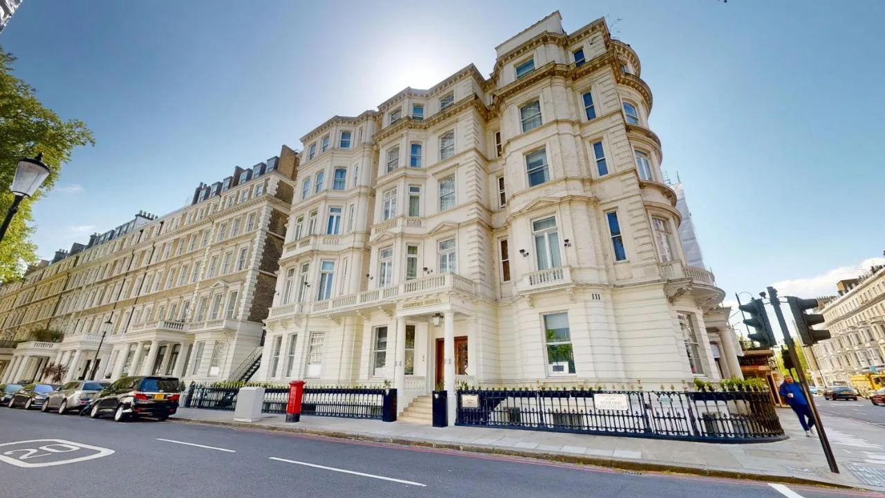 a large white building on the side of a street at Ashburn Hotel in London